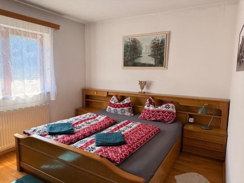 a bedroom with a bed with red pillows on it at Chalet Ad Alta - Flattach in Flattach