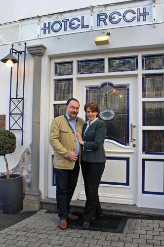 a man and woman standing in front of a hotel room at Hotel Rech in Brilon