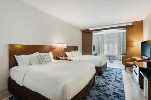 a hotel room with two beds and a television at Fairfield Inn & Suites by Marriott Durango in Durango