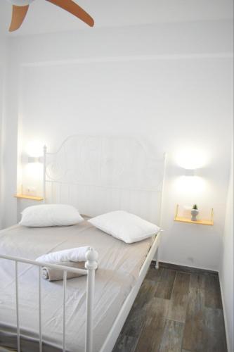a white bed with white sheets and pillows in a room at Zk House Kythnos in Mérikhas