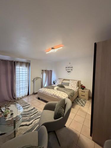 a bedroom with a bed and a couch and a table at Apartchrisbea in Namur