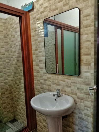 a bathroom with a sink and a mirror at Carpenters homestay in Sagada