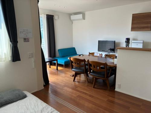 a room with a table and chairs and a dining room at Leaf Village in Tokorozawa