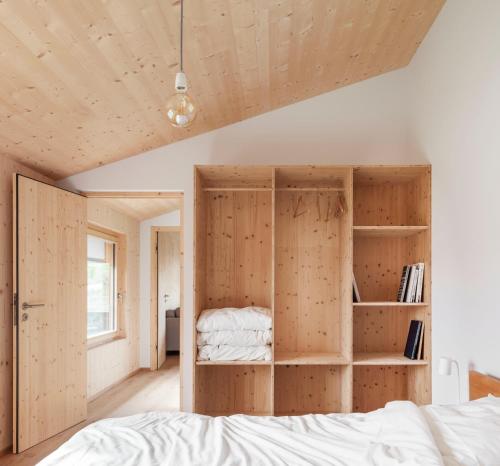a bedroom with wooden walls and a bed at Haus Kienzerleweg in Bad Kohlgrub