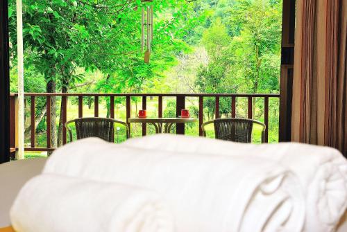 a view of a balcony with a table and chairs at Moosiyard Hometel Khaoyai in Mu Si
