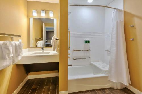 a bathroom with a shower and a sink at TownePlace Suites by Marriott Grand Rapids Airport Southeast in Grand Rapids