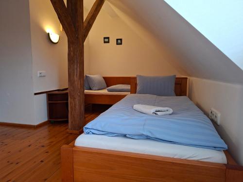 a bedroom with a bed and a tree at Hostinec u Janatů s ubytováním in Čestín