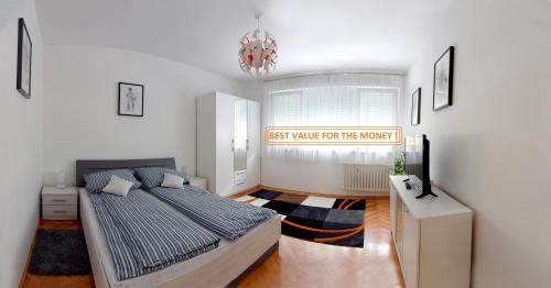a bedroom with a bed and a sign that reads first walk for the moon at Apartmani Vedmar in Zagreb