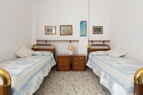 a room with two beds and a table with a lamp at Apartment Vincenzina in Monterosso al Mare