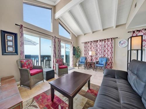 a living room with a couch and chairs at Oceanfront withIncredible Beach Views home in Newport Beach