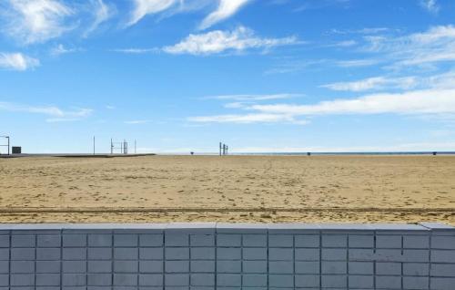 a view of the beach from a brick wall at Value Beachfront withLarge Patio On The Bike Path apts in Newport Beach