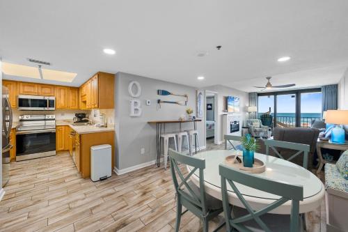 a kitchen and living room with a table and chairs at Phoenix II 2012 in Orange Beach