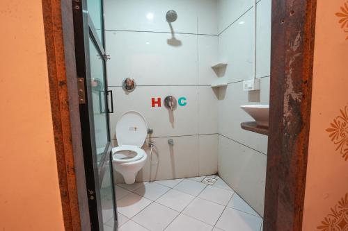 a bathroom with a toilet and a sink at Hotel Tulsi in Nadiād