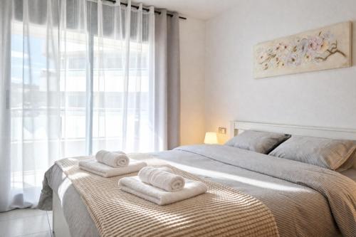 a bedroom with a bed with towels on it at Belice 1-6 in Lloret de Mar