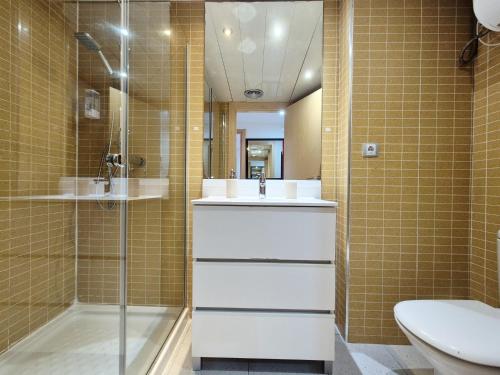 a bathroom with a sink and a shower and a toilet at Belice 1-6 in Lloret de Mar