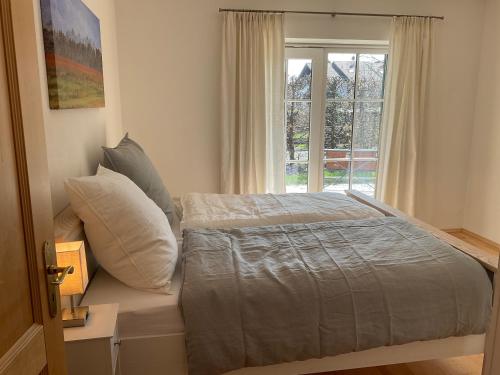 a bedroom with a bed and a window at See & Natur Apartment Uffing in Uffing