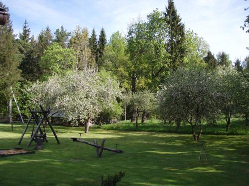 a park with a swing set in the grass at Sodyba Duburiai in Ukmergė