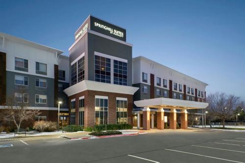 a hotel with a parking lot in front of it at SpringHill Suites by Marriott Fort Collins in Fort Collins