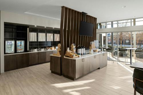 a lobby with a counter with a tv on it at SpringHill Suites by Marriott Fort Collins in Fort Collins