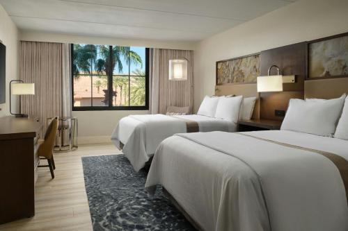 a hotel room with two beds and a desk at The Westin Lake Las Vegas Resort & Spa in Las Vegas