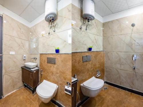 a bathroom with two toilets and a shower at Fortune Inn Sector - 104 By ASPL in Noida