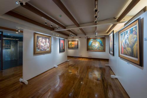 a large room with paintings on the walls at Grand Sierra Pines Baguio in Baguio