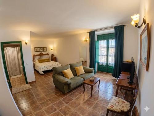 a living room with a couch and a bed at Hotel Palacio Buenavista in Belmonte