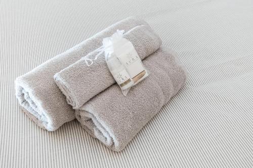 a pile of towels sitting on top of a bed at -Fronte Mare- Centro Storico in Varazze