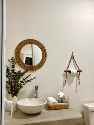 a bathroom with a sink and a mirror on the wall at Bamboo in El Paredón Buena Vista