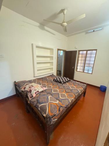 a large bed in a room with a ceiling at Hibisco Hideout in Meenangadi