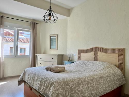 a bedroom with a large bed and a window at Apartment Monica by Moraira Holiday Homes in Moraira