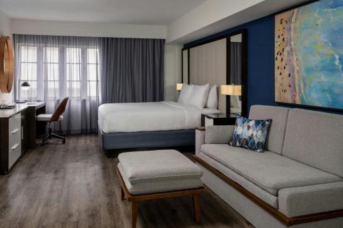a hotel room with a bed and a couch at Courtyard Miami Beach South Beach in Miami Beach