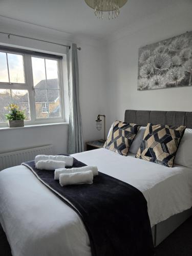 a bedroom with two beds with towels on them at The Flexible Lodge-Ashford in Kingsnorth