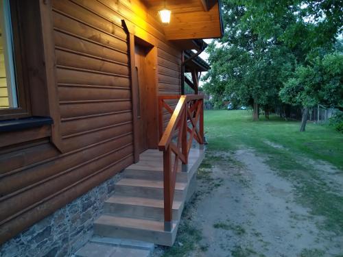 a wooden stairway leading to a house at Domek NAD RZEKA in Korczew