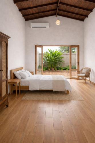 a bedroom with a bed and a large window at Villa 55 Galle in Galle