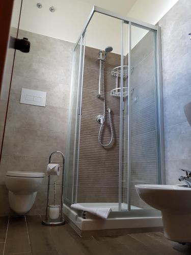 a bathroom with a shower and a toilet and a sink at Hotel La Martinica in Ficarazzi