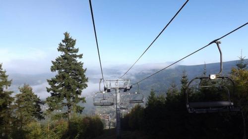 a gondola ride up a mountain in the mountains at Hotel Anna in Harrachov