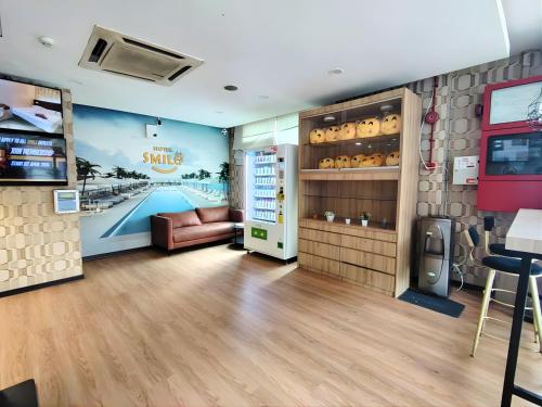 a restaurant with a bar with a couch and a room at Smile Hotel Cheras Pudu KL in Kuala Lumpur