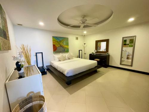a bedroom with a bed and a ceiling at Kata Seaview Escape - 1BR Luxury Apartment 90sqm in Phuket