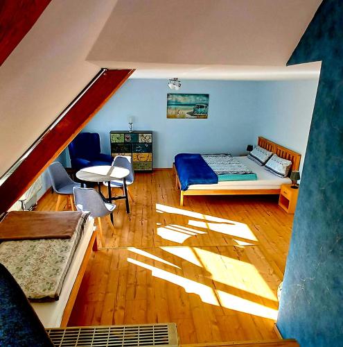 a bedroom with a bed and a table in a room at Sonnentor in Bad Wurzach