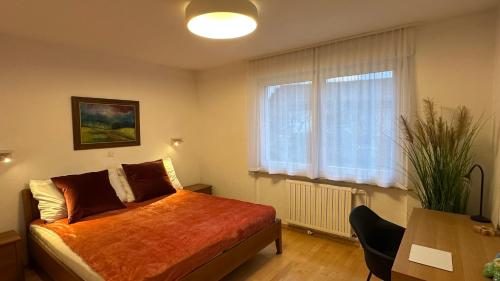 a bedroom with a bed and a table and a window at Ani's Pearl in Bled