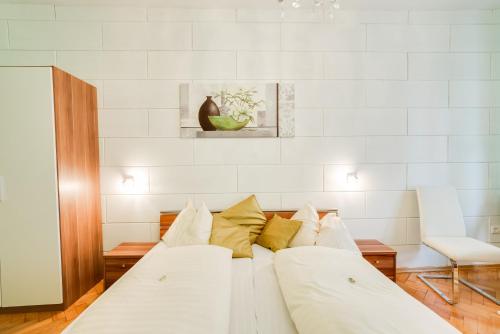 a white bed with pillows on it in a room at Hotel Himmelreich in Mariazell