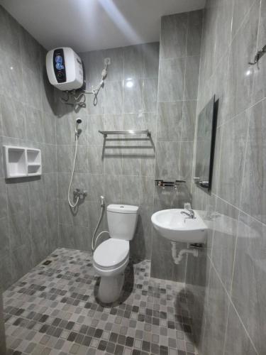 a bathroom with a toilet and a sink at ERCA Yogyakarta in Yogyakarta