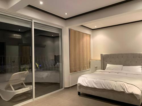 a bedroom with a bed and a sliding glass door at Villa Dreamy Pool Garden in Eilat