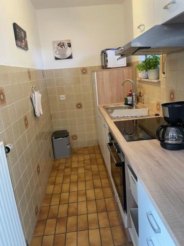 a small kitchen with a sink and a counter at Bungalow Orketal Sauerland in Medebach