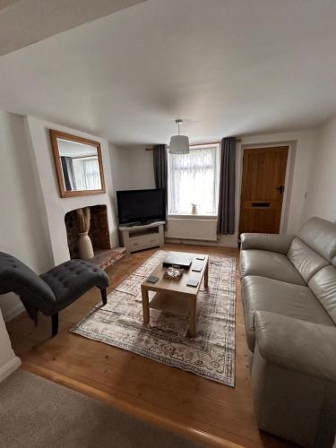 a living room with a couch and a coffee table at Mundesley Cosy cottage in Mundesley