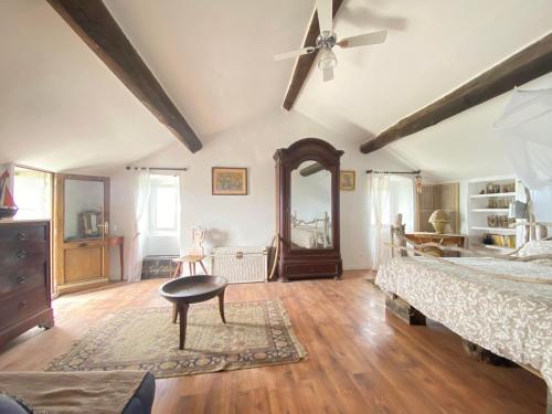 a bedroom with two beds and a ceiling fan at Chambre des rêves, vue exceptionnelle sur terrasse privée,la Casamatta in Centuri