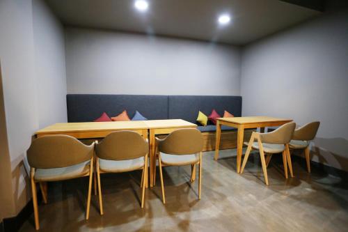 a room with a table and chairs in a room at With U Hotel & Guesthouse in Sokcho