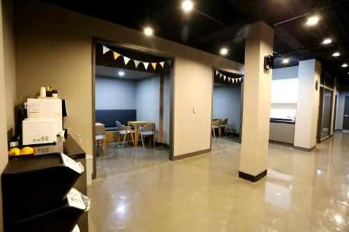 a large room with chairs and a table in it at With U Hotel & Guesthouse in Sokcho