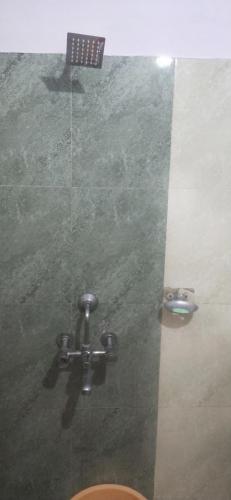 a shower in a bathroom with an american flag on the wall at Hotel Raj Guest House in Jaipur